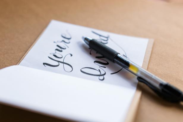 Use a felt-tip pen to write in party details on the blank pages of the invitation.