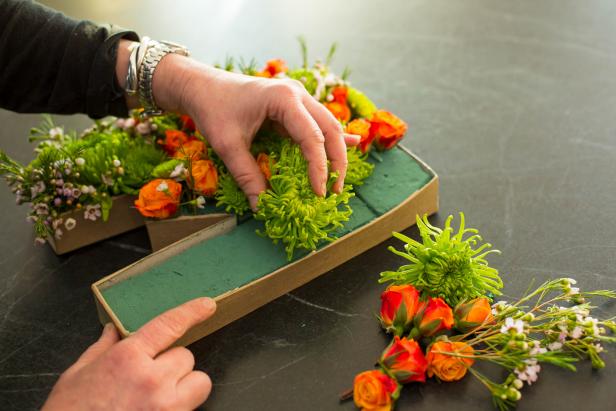 Push flower stems into the floral foam. Use a variety of colors and blooms to create an eye-catching arrangement!