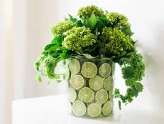 Green Flowers in Vase With Lime Slices