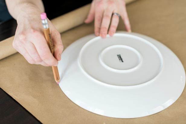 Use a dinner plate and pencil to trace a large circle shape onto brown craft paper.