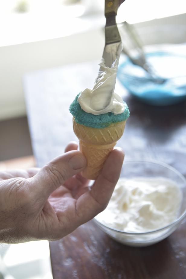 Use a frosting spreader to put frosting into a small bowl, stir and frost cupcakes.