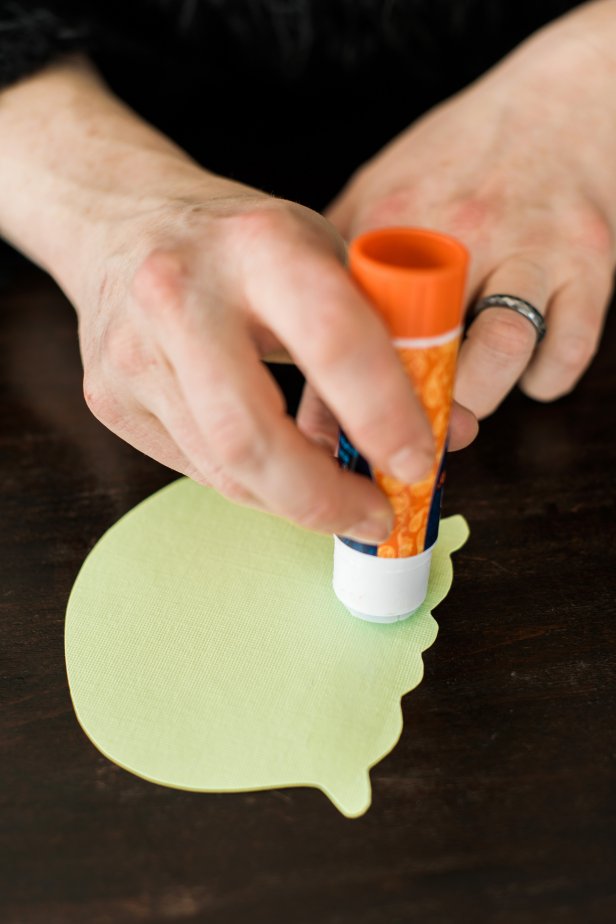 Use the glue stick to apply a thin layer of glue to the bottom of the scoop and attach to the top of the cone.