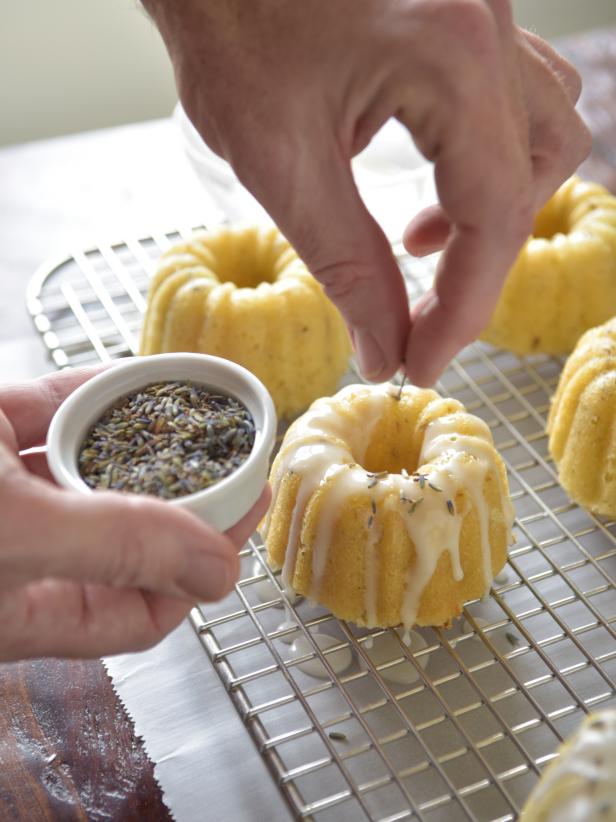 Sprinkle loose lavender onto the cakes with the lavender falling into the poured icing.