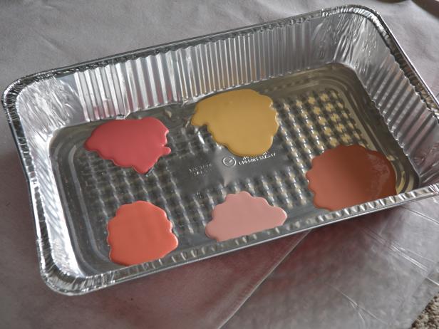 Pour a three-inches-wide puddle of each chosen paint color into the large foil pan, keeping each color separated by at least two to three inches.