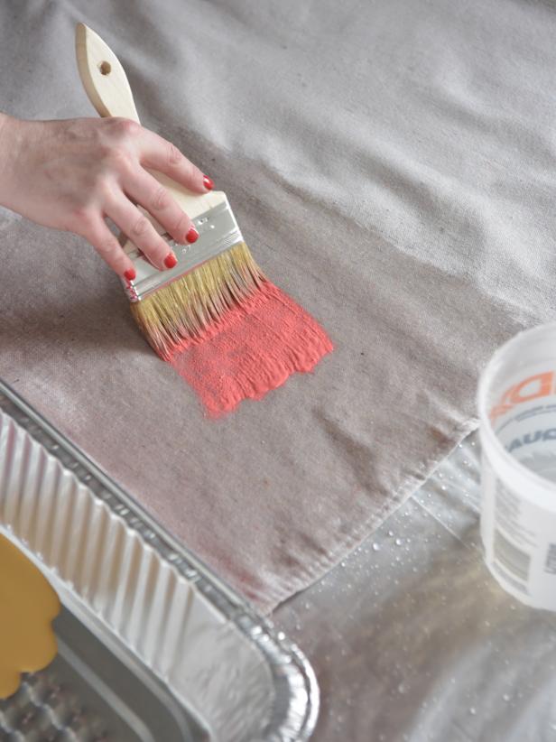 Dip the chip brush into one color of paint and loosely brush it over the wet rectangular area. The paint will spread and begin to bleed, taking on a watercolor look.