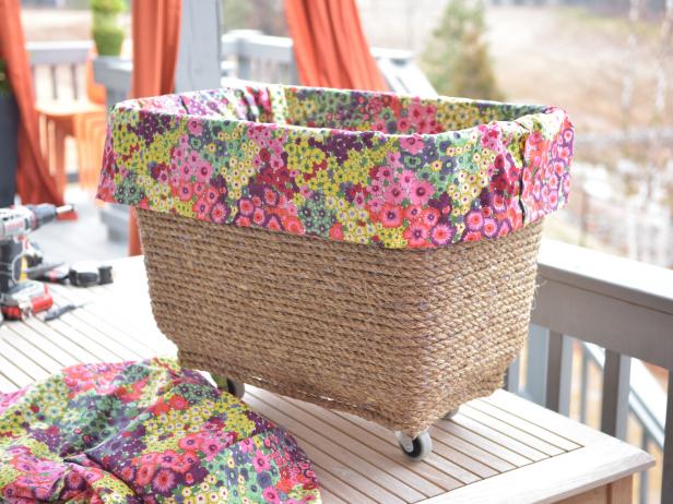 Breathe new life into a basic plastic storage bin with jute rope, hot glue, lumber and metal casters.