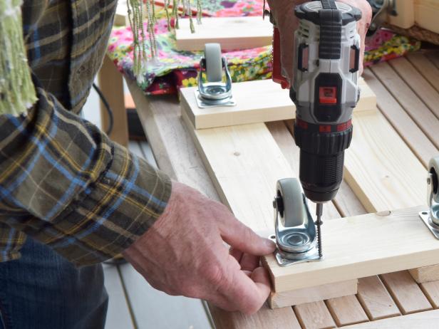 Add all four casters to the width strips using drill and 3-inch wood screws.