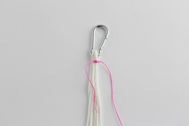 Cut a 20â piece of pink rope. Tie around all 8 strands. Wrap around all eight strands until there is a few inches of pink rope left. Tie off.