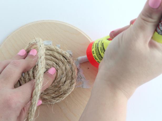 Continue to glue and wrap until the entire wooden circle is covered in rope.