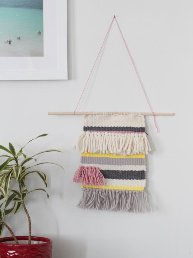 Use a wooden handloom to create a custom, woven tapestry for your wall. Use any colors or types of yarn to create stripes and fringe. This project can easily be finished in a few nights while watching your favorite TV show.