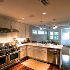 Open Plan Kitchen Features Stainless Steel Oven & Beautiful White Cabinetry