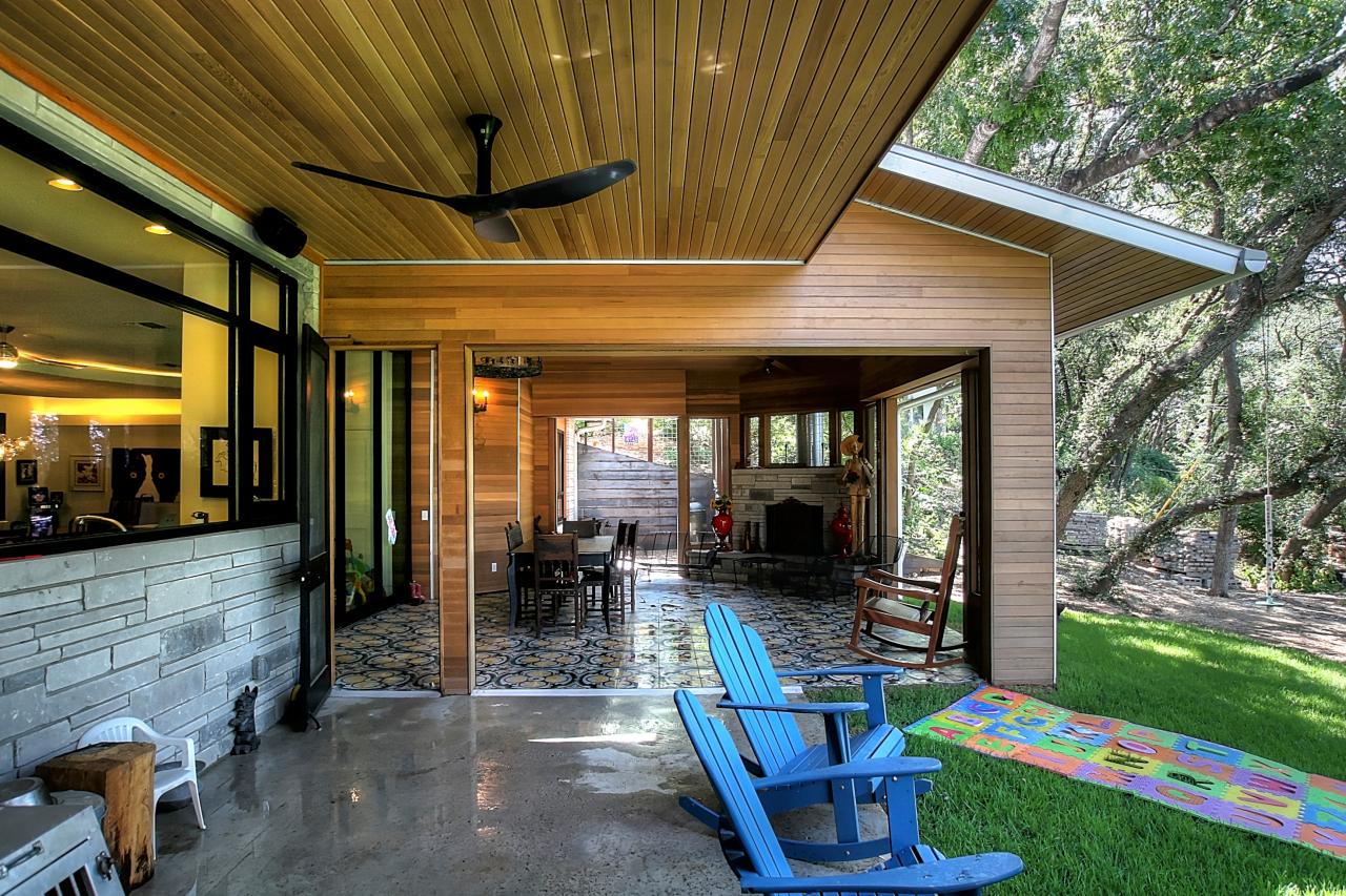 Covered Porch Features Blue Adirondack Rocking Chairs | HGTV