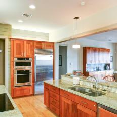 Open Kitchen Features Granite Countertops & Warm Wood Cabinets