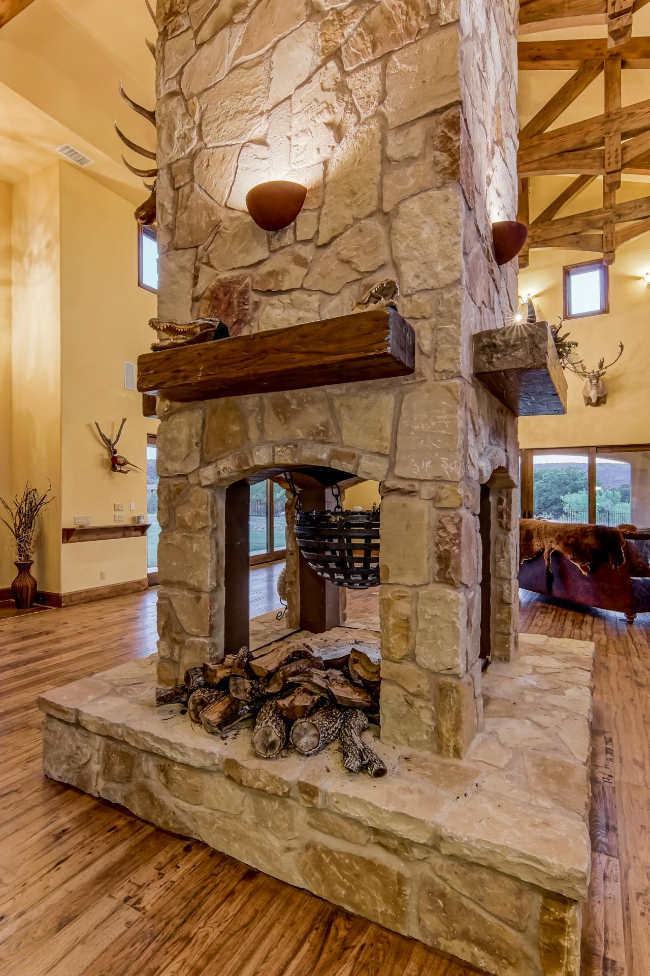 FourSided Fireplace With Rustic Mantels HGTV