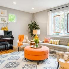 Gray Transitional Living Room With Orange Ottoman