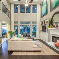 White Coastal Living Room With High Ceilings