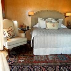 Neutral Southwestern Bedroom With White Armchair