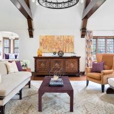 Great Room Features Exposed Beams and Regal Purple Accents