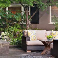 Lush Foliage Surrounds Chic Outdoor Seating Area