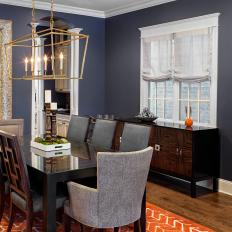 Transitional Navy Dining Room With Delicate Gold Chandelier