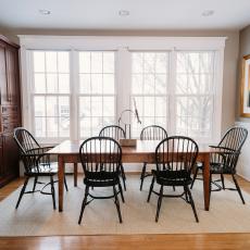 Bright Transitional Dining Room Features Black Windsor Chairs