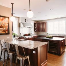 Transitional Eat-In Kitchen Features Metal Barstools & Dark Wood Cabinetry