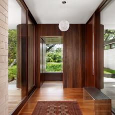 Bright, Modern Foyer Features Striking Wood Accents