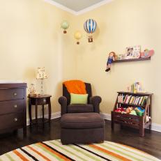 Child's Bedroom With Circular Striped Rug & Rich Brown Furnishings