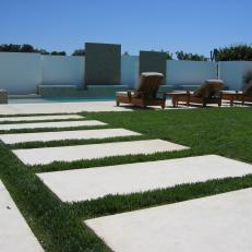 Contemporary Backyard Pool With White Stone Walkway
