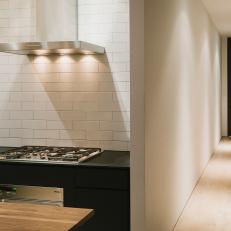 Modern Black and White Kitchen With Light Hardwood Floors