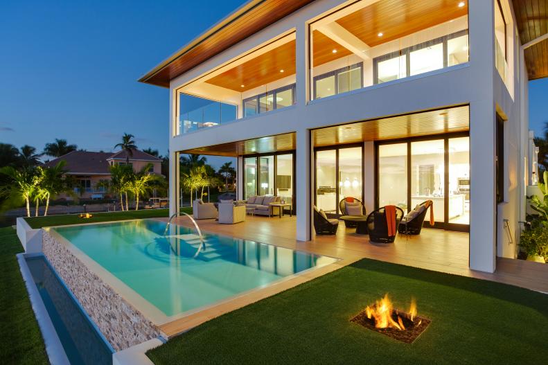 Back Exterior of Modern Home With Covered Patio and Infinity Pool