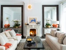 Pale Blue Living Room With Brown Mirrors, Neutral Sofa & Orange Accent