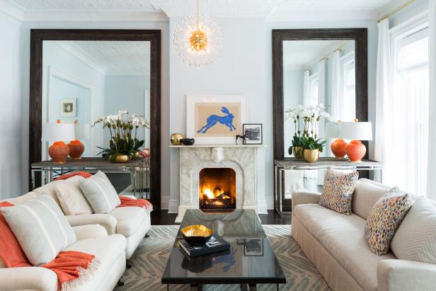 Pale Blue Living Room With Brown Mirrors, Neutral Sofa & Orange Accent