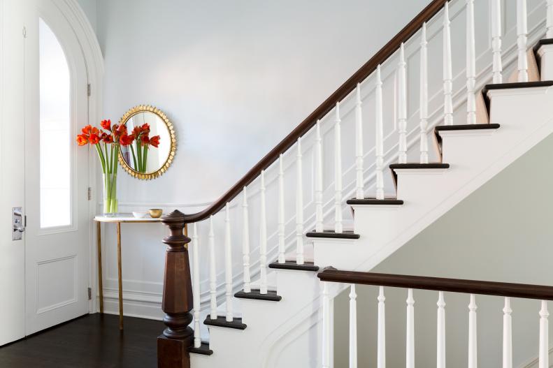White Entryway With Dark Wood Floors and White Wainscoting