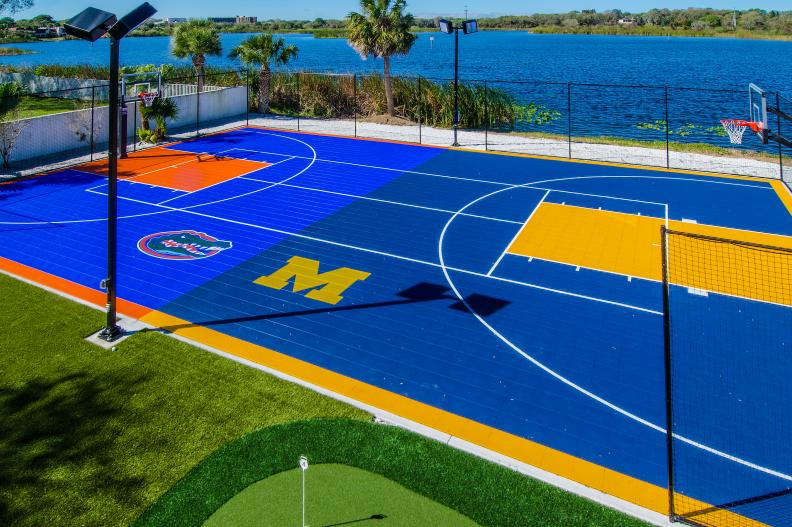 Blue Outdoor Basketball Court With Florida and Michigan Logos