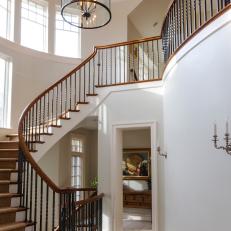 Entryway Features Winding Staircase & Cylinder Pendant Light