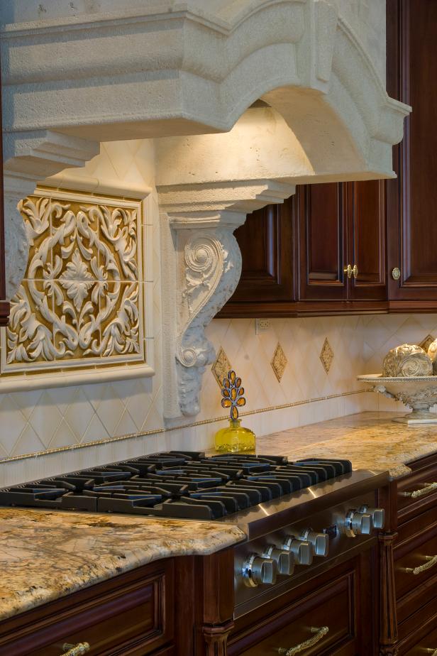 Cast Stone Range Hood & Neutral Kitchen Backsplash | HGTV