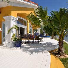 Yellow Mediterranean Home Boasts Large White Deck