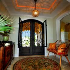 Striking Foyer With Wrought Iron Doors