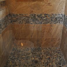 Neutral Tile Shower Boasts Sliced Pebble Accents