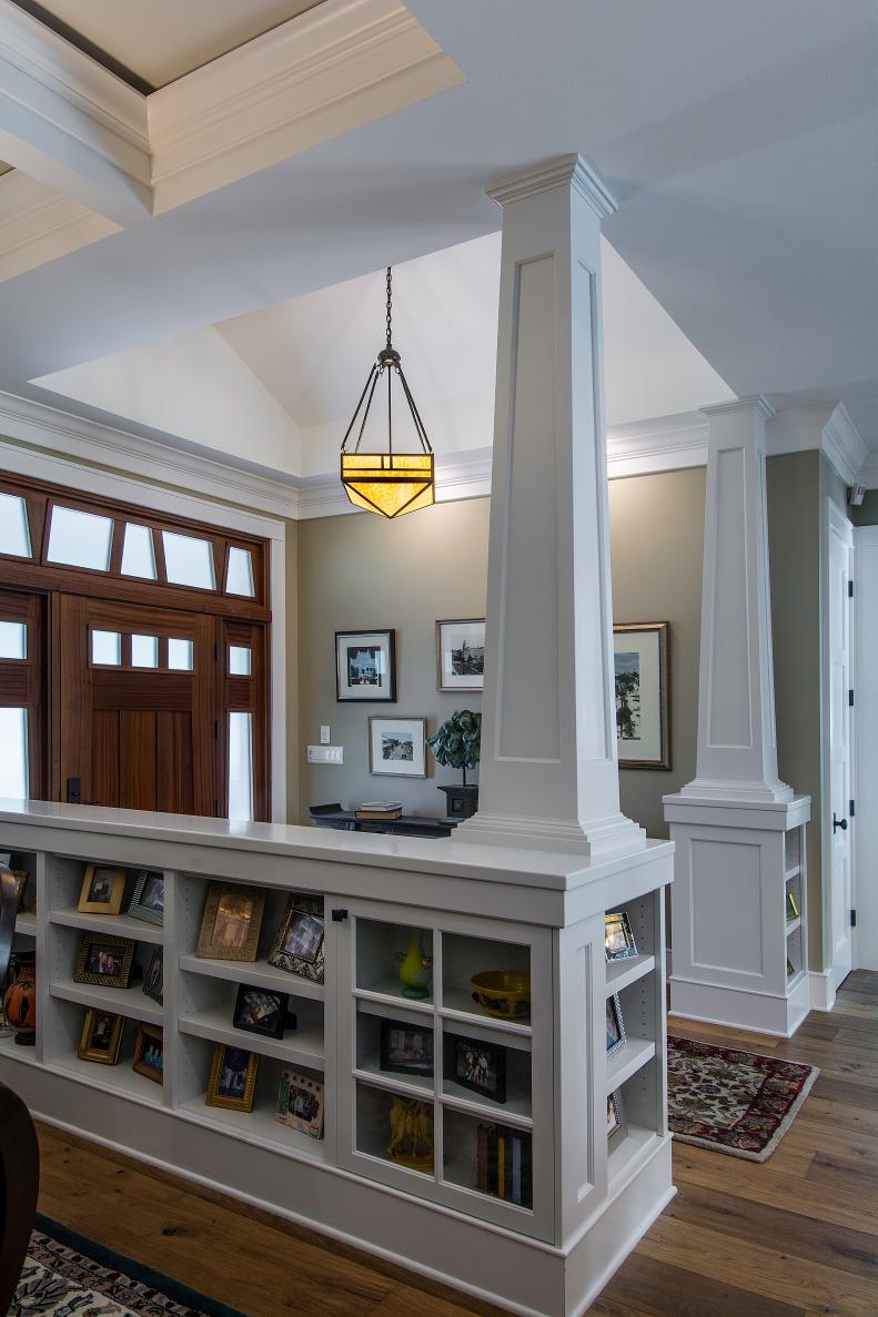 Taupe and White Foyer With Columns and Built-In Bookcases