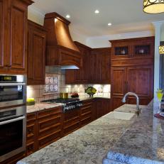 Traditional Kitchen With Brown Cabinets & Two-Tier Island