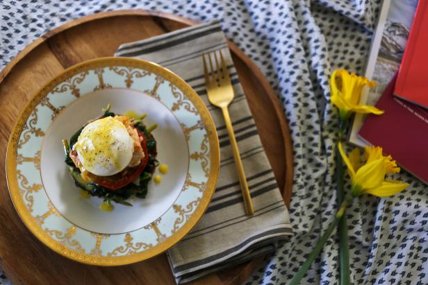 Add a twist to classic eggs Benedict with baked salmon, sauteed spinach and roasted tomatoes.