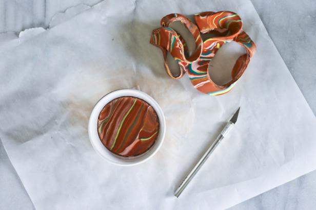 Make Mom a clay jewelry dish this Mother's Day. The turquoise and gold marbled accent colors add glamour to the terra cotta-colored dish.