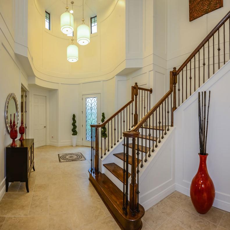 Eclectic, Two-Story Foyer With Wooden Staircase