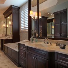 Luxe Bathroom Boasts Rich Brown Cabinets & Marble Floors
