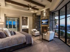 Rustic Bedroom With Stone Fireplace, Floor-to-Ceiling Windows