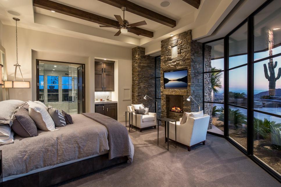 Rustic Bedroom With Stacked Stone Fireplace