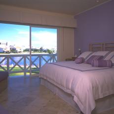 Bedroom With Periwinkle Accent Wall & Waterfront View