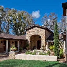 Tuscan-Style Home Exterior With Stone Archway